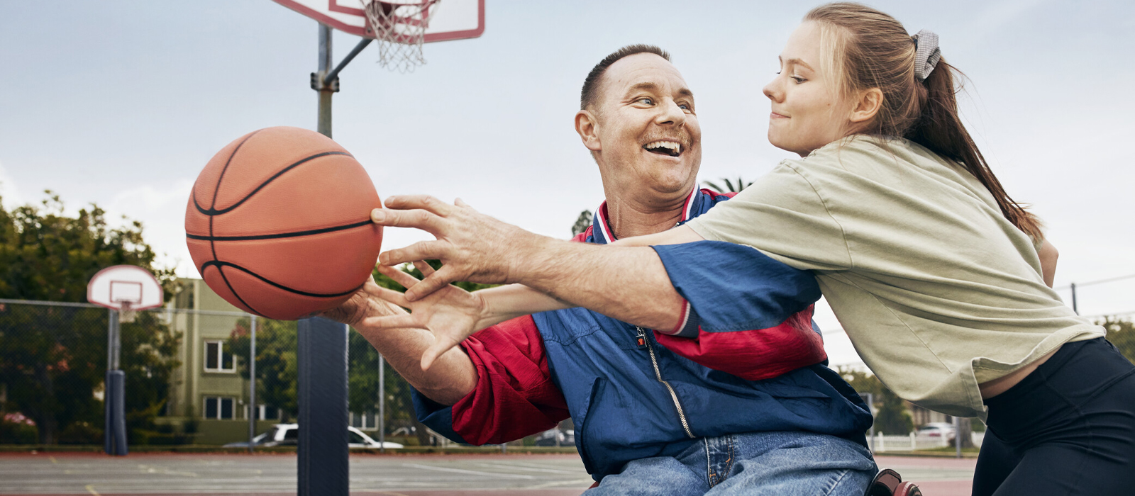 Picture of Bob playing basketball in wheelchair with his daughter